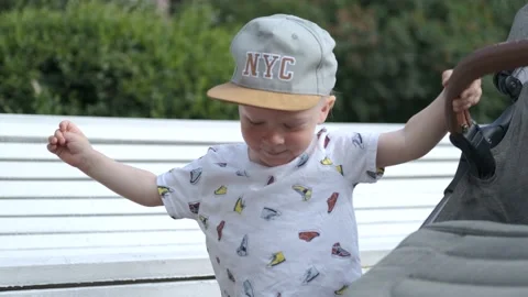 Little boy walking holding the stroller Video stock 157376910