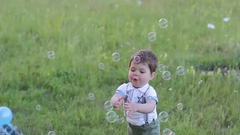 Little boy is walking on the lawn Stock Footage 79030802