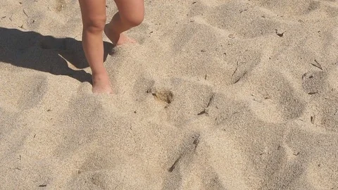 Little boy is walking on sand at the beach. Slow Motion Stock Footage 81577997