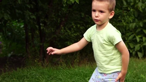 Little boy waves his hand into the camera. Slow motion Stock Footage 80051056