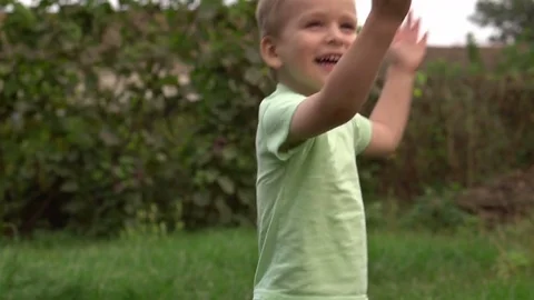 Little boy waves his hands joyfully. Slow motion Stock Footage 80051066
