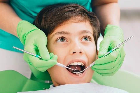 Little boy while teeth exam. Dental exam teeth to a children Photos