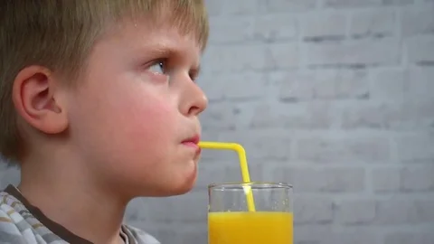 Little boy on white background having some juice for breakfast, hd video Stock Footage 73281958