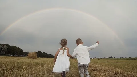 Little boy in a white shirt and a little girl in a white dress with long hair Stock Footage