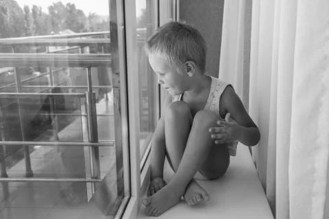 Little boy on the window Stock Photos