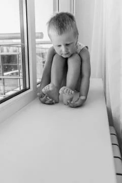 Little boy on the window Stock Photos