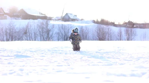 Little boy in a winter cap playing in the snow Stock Footage 61303839