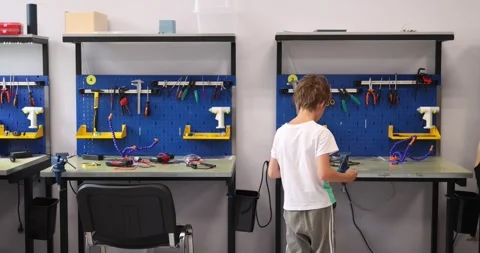 Little boy working and learning in workshop with tools Stock Footage 295105295