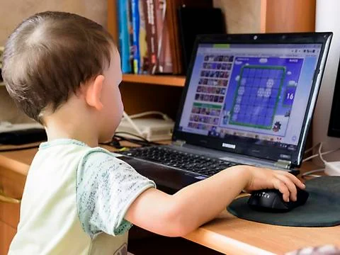 A little boy is working on the computer Stock Photos