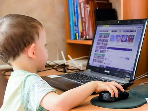 A little boy is working on the computer Stock Photos