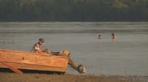 Little boy working hard while other children playing Stock Footage 26095720