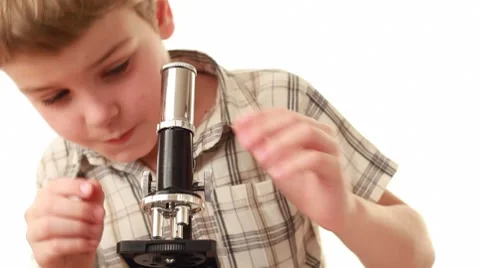 Little boy works with microscope making some research Stock Footage 8510098