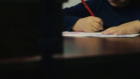 Little boy is writing at the table Stock Footage 73741438