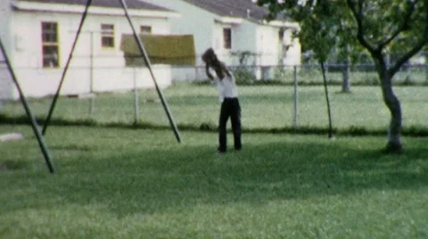 Little BoyThrows Backyard Baseball Suburban 1960s Vintage Film Home Movie 1898 Stock Footage 10569704