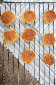 Little bread buns on baking wire Stock Photos