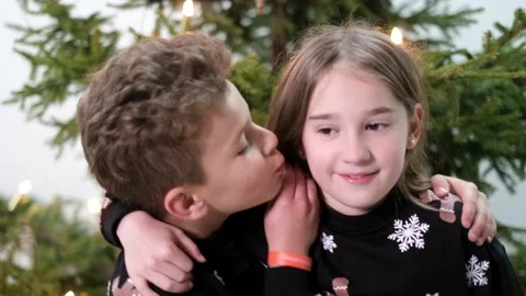 Little brother kisses his sister on the ... | Stock Video | Pond5