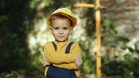 Little builder in helmet. Child dressed as a workman builder. Portrait little Video stock 229735941