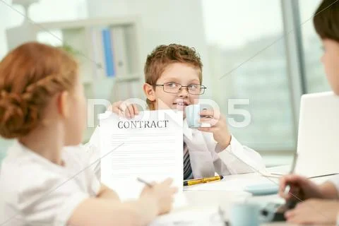 Little businessman showing contract to his colleagues Stock Photos