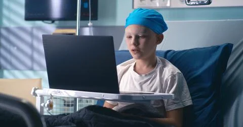 Little cancer patient making video call in clinic Stock Photos