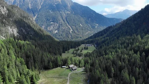Little chalet nested in the mountain scenic aerial shot Stock Footage 96111301
