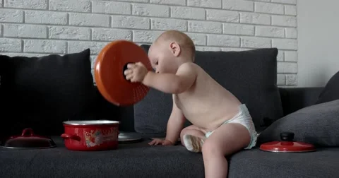 Little Chef Boy in the Kitchen Playing With Pan, Pots and Ladle 動画素材 65782259