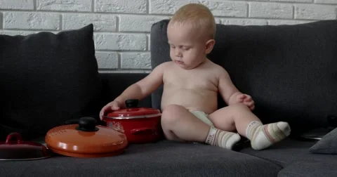 Little Chef Boy in the Kitchen Playing With Pan, Pots and Ladle Stock Footage 65782279