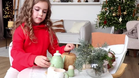 Little chef creates magic with festive table setting in cozy home 스톡 동영상 296324587