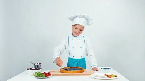 Little chef decorating the cake using chocolate Stock Footage 66200734