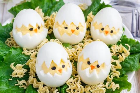 Little chicken in nest, deviled eggs served with salad and dry ramen on whi.. 写真素材