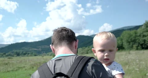 Little Child Being Carried by His Father Outside in the Field Stock Footage 67052953