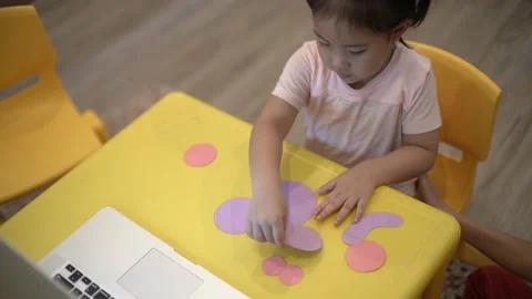 Little child creating elephant shape from colored paper Video stock 159377027