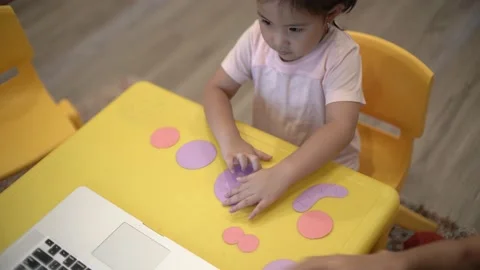 Little child creating elephant shape from colored paper Video stock 159377029