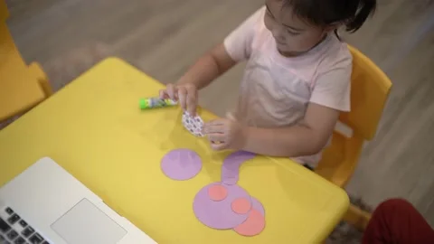 Little child creating elephant shape from colored paper Video stock 159377093