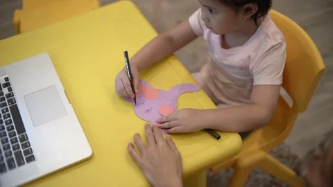 Little child creating elephant shape from colored paper Video stock 159377119