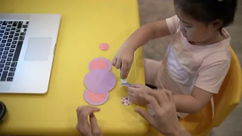 Little child creating elephant shape from colored paper Video stock 159377121