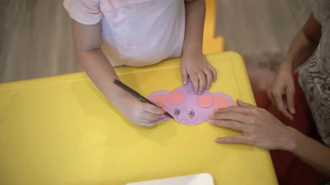 Little child creating elephant shape from colored paper Stock Footage 159377170