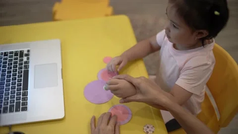 Little child creating elephant shape from colored paper Video stock 159377200