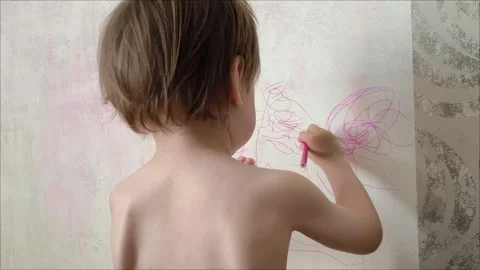 Little child drawing scribbles on wall with pink marker Video stock 322807965