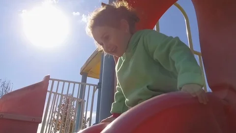 Little Child Girl Play On Park Playground Slide -Slow Motion