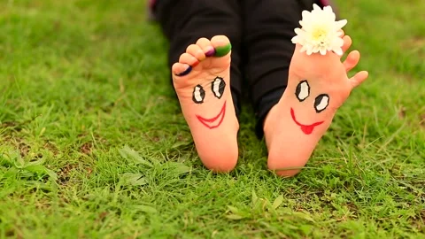 Little child girl sits on green grass wi... | Stock Video