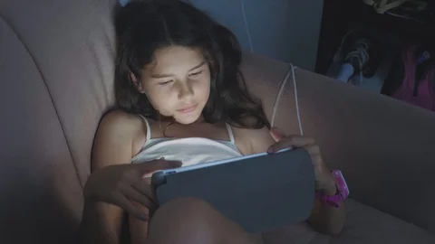 Little child girl using tablet at night.... | Stock Video - Pond5   