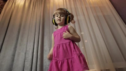 Little child girl in wireless headphones... | Stock Video 