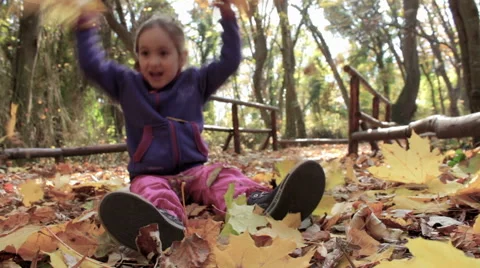 Little child having fun with leafs in the forest 動画素材 57227100