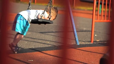 Little Child having fun on the swing Stock Footage 79976270