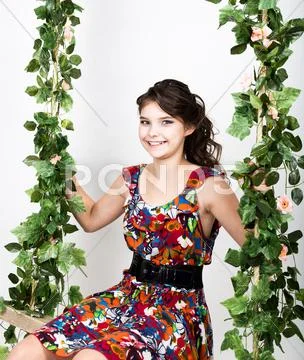 Little child having fun on a swing. girl swinging on flower swing Stock Photos