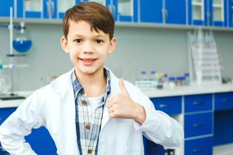 Little child with learning class in school laboratory thumb up Stock Photos