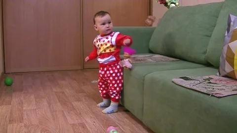 Little child playing with a doll Stock Footage 89570653