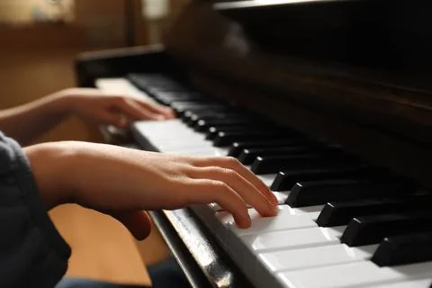Little child playing piano, closeup. Music lesson Stock Photos