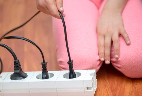 Little child playing with plug Stock Photos