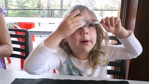 Little child playing with spoon Stock Footage 76768116